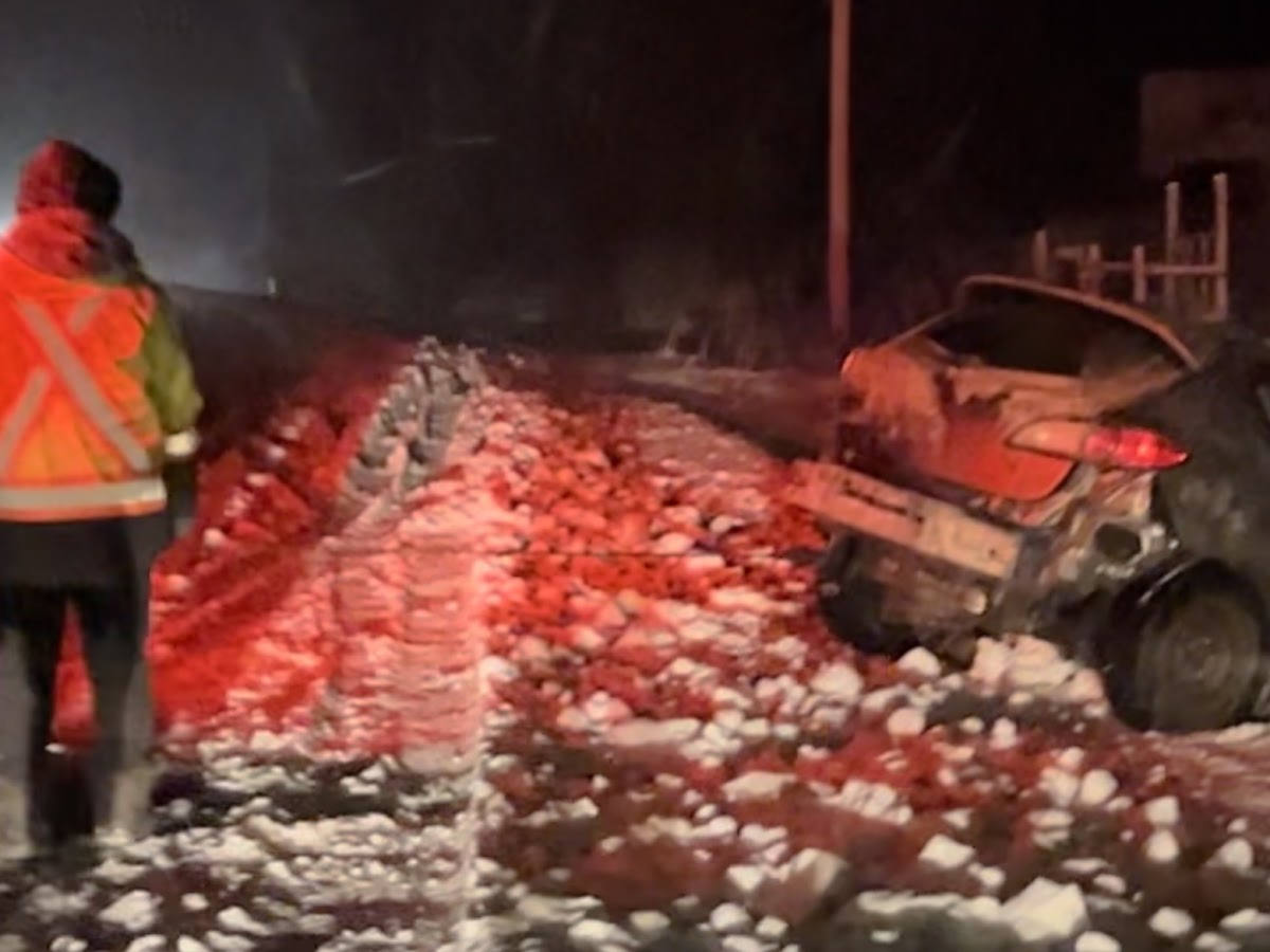 A stranded vehicle on a snow-covered road at night — the kind of call Most Valuable Towing answers 24/7.